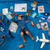 Elizabeth Dalziel's son Joe, 7, lays next to his favorite objects, toys and books as part of a homeschooling assignment — to create a time capsule — from his school in Berkhamsted, England.
