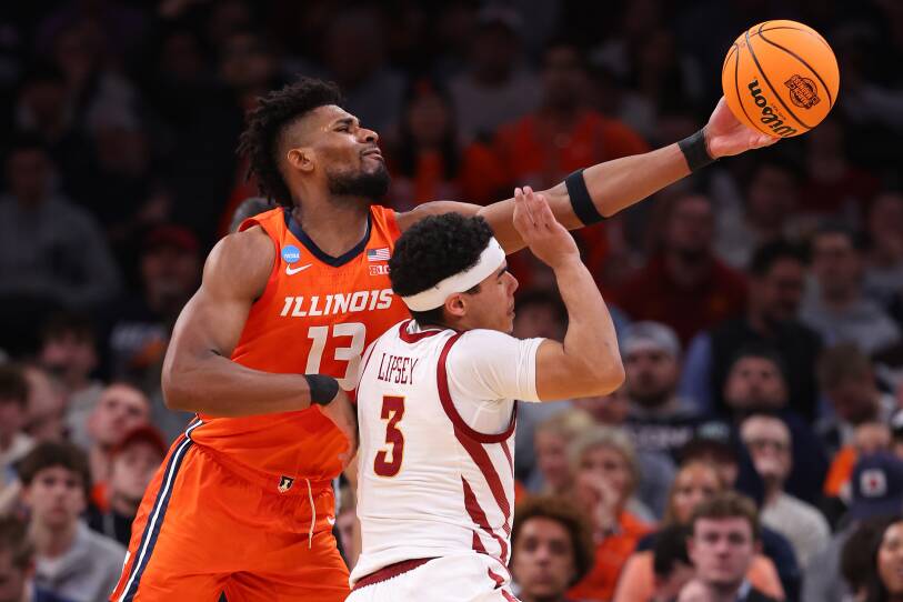Two players clash on the court in front of a packed arena.