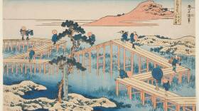 Katsushika Hokusai's "Old View of the Eight-plank Bridge in Mikawa Province," featuring a woodblock print of a wooden footbridge with lots of turns. Several people walk across the bridge.