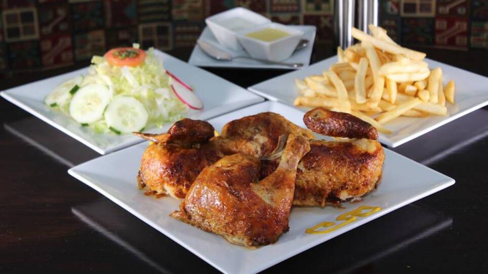 Chicken, salad, fries and two dipping sauces at Machu Chicken.