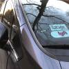 Uber and Lyft sign in windshield of car, Queens, New York.