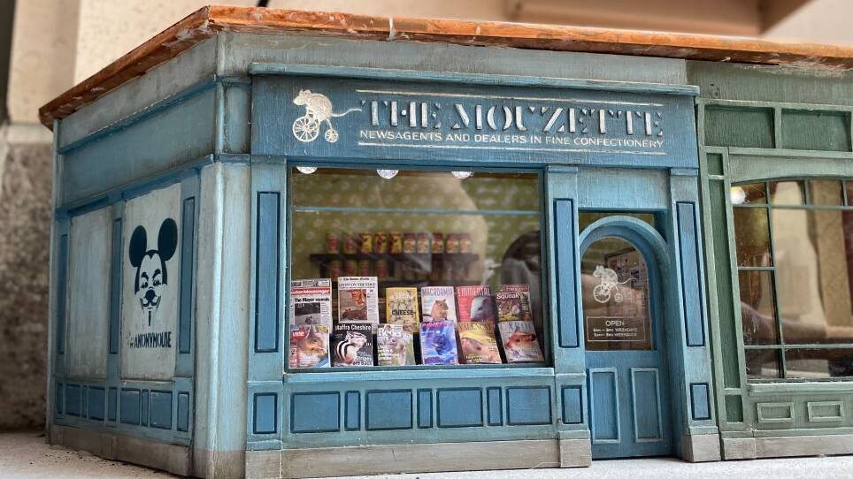 A tiny mouse-sized newsstand on a Boston street, featuring magazines with titles like "National Mocrographic," "Emmental," "Squeak" and "Rodents."