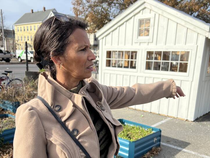 Maria Fortes, community engagement manager at Groundwork Southcoast, shows a visitor the community garden at New Bedford's Riverside Park.