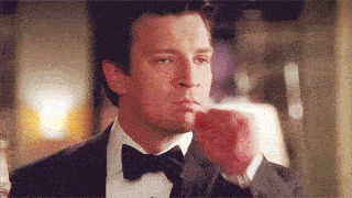 A man frantically gestures as if to say "stop shhh be quiet"