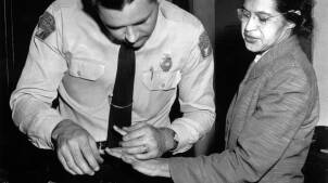 A police officer fingerprints Rosa Parks.