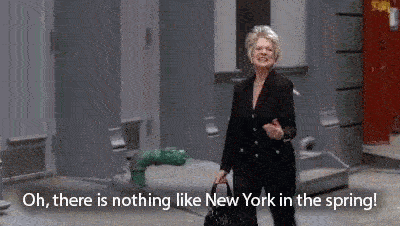 A woman happily exclaims "oh there is nothing like New York in the spring!" before getting shoved into a pile of garbage by a passerby