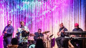 A band performing on stage at Grace by Nia in the Seaport.