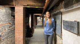 A woman poses in a dimly-lit hallway inside the Old North Church