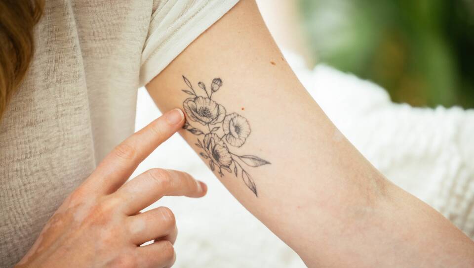 Stickler displays the poppy tattoo she got to commemorate her time on Broadway as an understudy for Elphaba in Wicked. After taking a coding boot camp, Stickler now works as a software engineer.