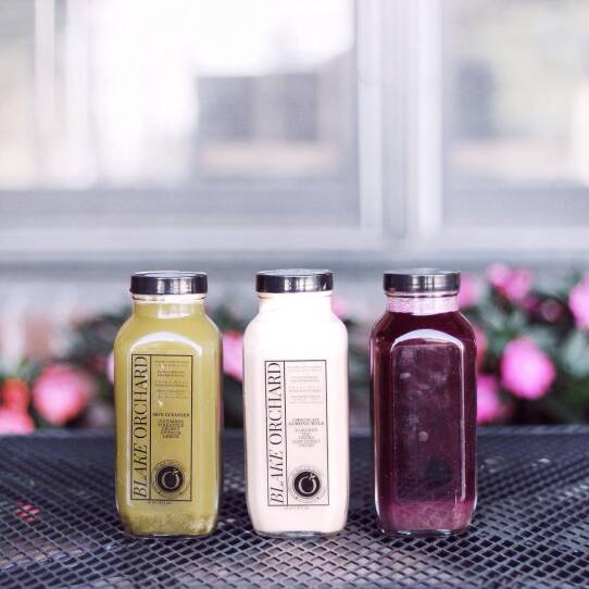 Organic cold-pressed juices and nut "mylks" in glass bottles, from Blake Orchard Juicery.