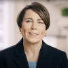 The attorney general, mid-speech, speaks directly to the camera from inside a home