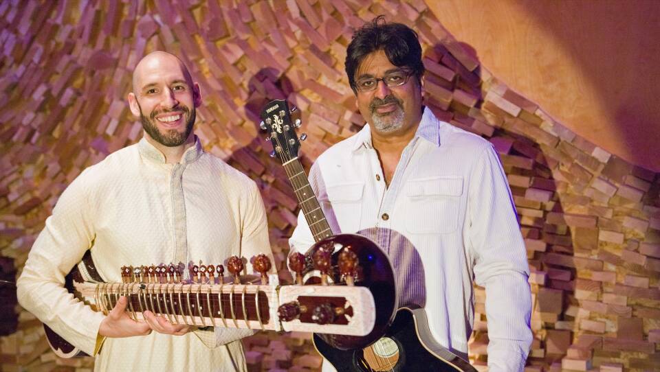 Naya Baaz members Josh Feinburg, holding a sitar and Rez Abbasi, holding a guitar.