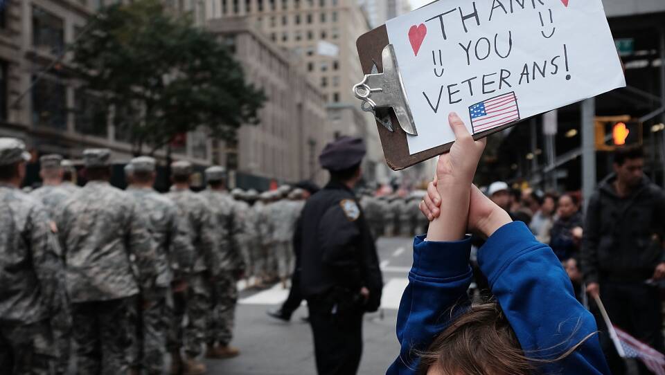 Gavin Kinney holds up a sign thanking veterans at the 2015 Veterans Day Parade in New York City.