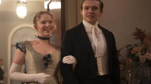 Shown from left to right: Laura Marcus as Young Eliza and Matt Olsen as Young William. The teens, dressed in party clothes, enter a soiree.
