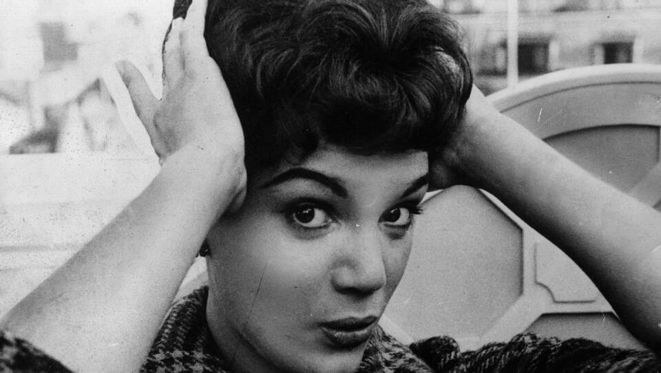 Connie Francis fixes her hair during a 1959 press reception at the Dorchester Hotel in London