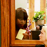 A woman pointedly holds up a note that reads "I told ya so!"