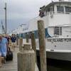 People disembark from a ferry in Bay Shore, N.Y., Saturday, Aug. 21, 2021, as it arrived from Fire Island. An evacuation order was ordered for the island due to the potential of damage due to Henri.