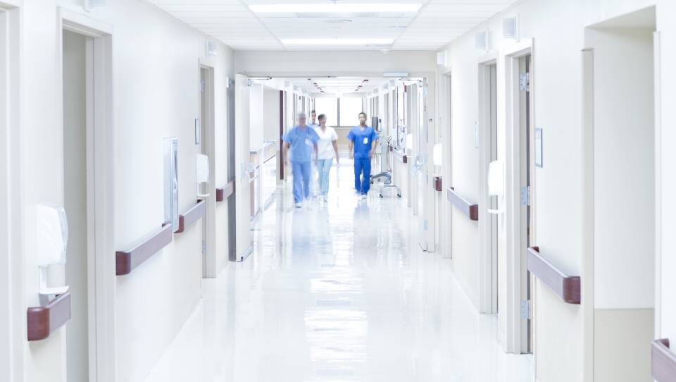 Doctors walking down hospital corridor