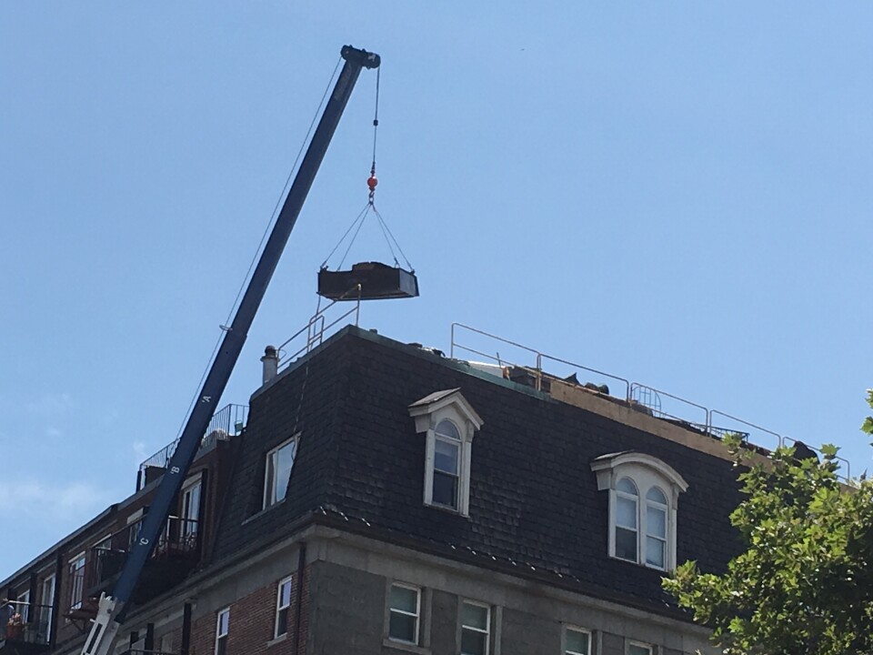 A section of the guardrail at the top of the building is missing