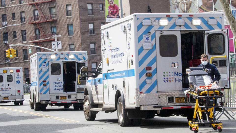 Ambulances line the street outside Elmhurst Hospital Center, on Saturday in the Queens borough of New York.
