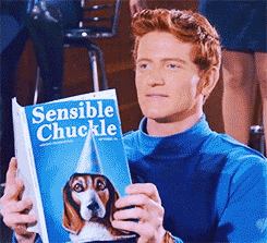 A man laughs while reading a magazine called Sensible Chuckle