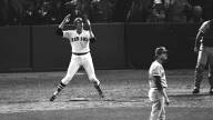 Carlton Fisk jumps and waves as he watches his ball fly.
