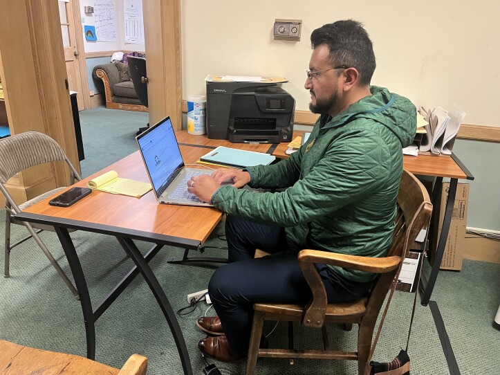 Leninn Torres, an organizer at the Pioneer Valley Workers' Center, translates birth certificates in English for undocumented immigrants applying for their Massachusetts driver's license.