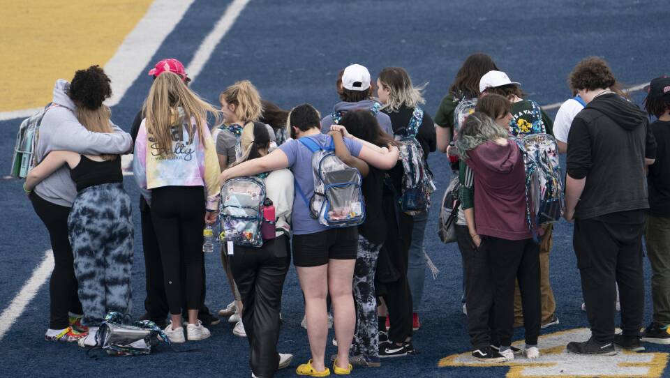 Oxford High School students embrace each other during Thursday's walkout.