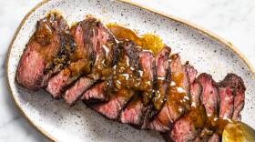 Plate topped with sliced medium-rare short ribs with a browned butter sauce