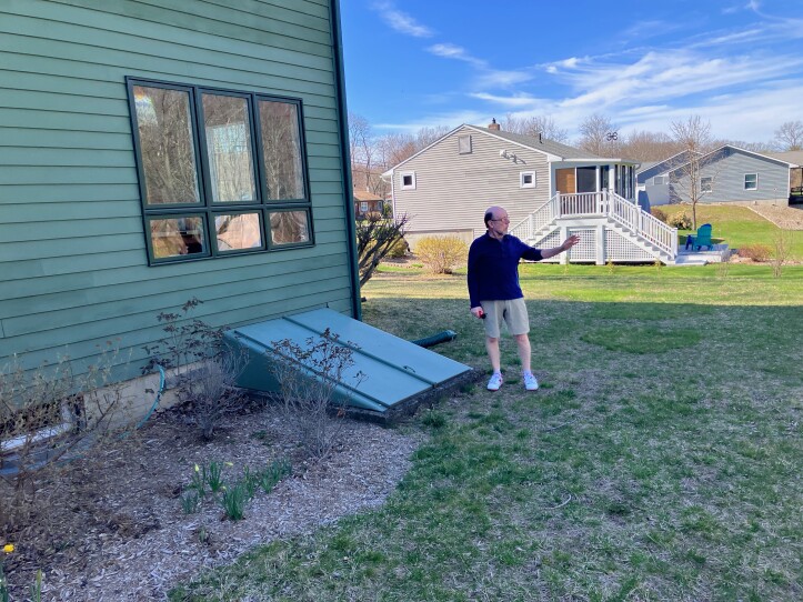Mike Davis removed a concrete patio outside his home in Florence, Massachusetts, and replaced it with grass. He said his sump pump is operating less frequently since he removed the impervious surface.