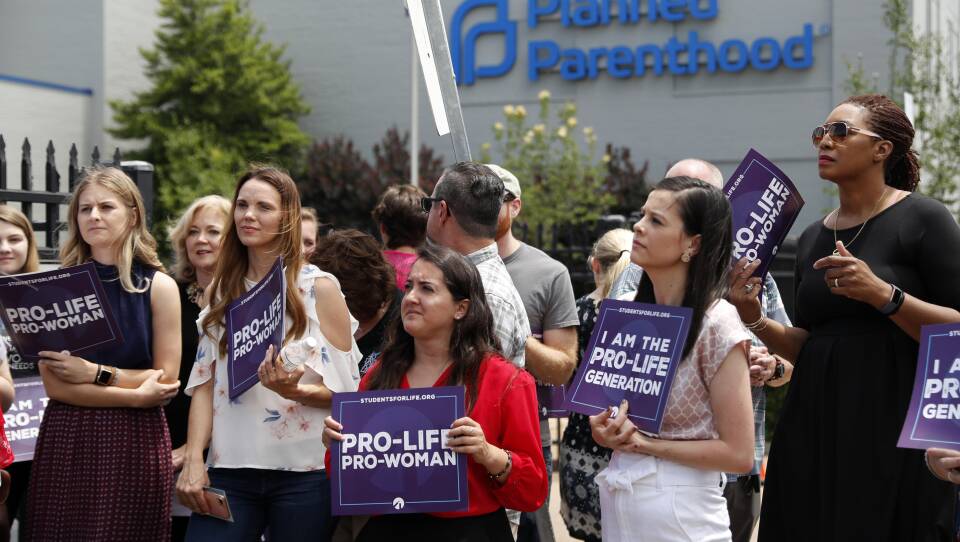 Anti-abortion-rights advocates gather outside a St. Louis Planned Parenthood clinic in June. Title X recipients have been given more time to comply with new regulations.
