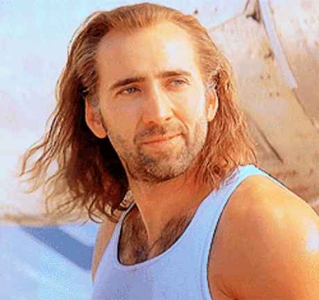 A man with flowing hair winks.