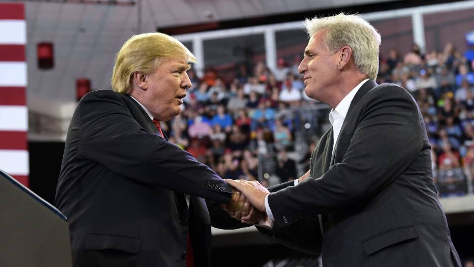 President Donald Trump, left, shakes hands with House Majority Leader Kevin McCarthy  during a rally this summer. If Republicans keep their majority, McCarthy could be the next speaker of the House.
