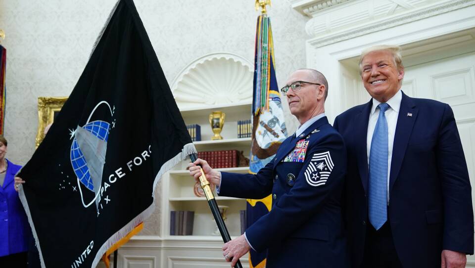 U.S. Space Force Senior Enlisted Advisor CMSgt Roger Towberman, standing with President Trump, presents the Space Force Flag in the Oval Office on March 15.