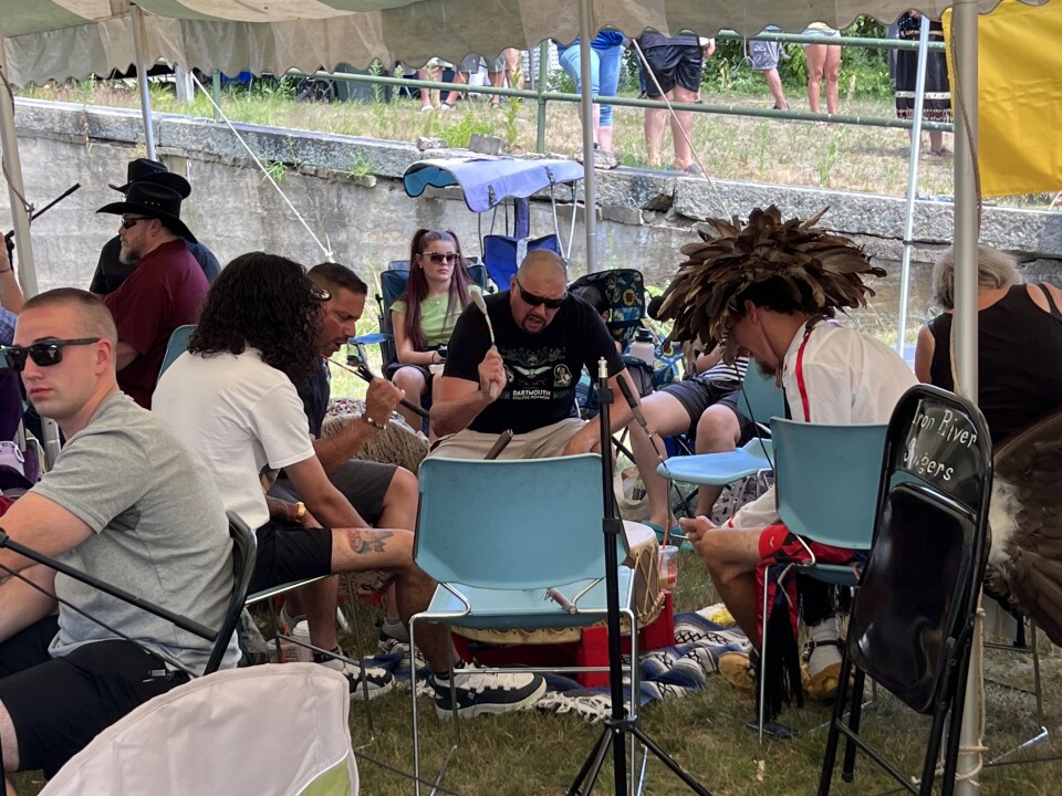 Men pounding on drums