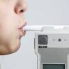 Woman Blowing in Breathalyzer