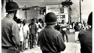 Troops and protesters face each other on Linwood Avenue during 1967 Detroit Race Riots