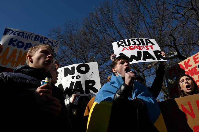 Students gathered outside holding signs.