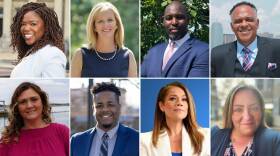 Eight headshots show men and women dressed in formal business attire, smiling or looking confidently into the camera.