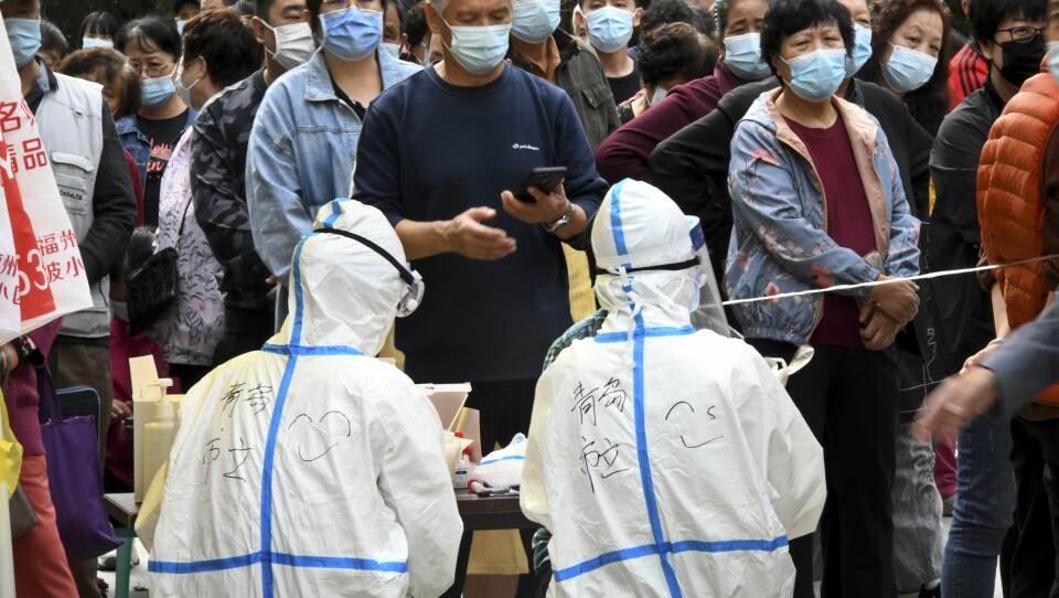 In this photo released by Xinhua News Agency, residents line up for COVID-19 tests in Qingdao this week. China says it has carried out 10 million tests in the northern port city, with no new cases found.