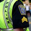 A close-up photo of a Boston Police officer wearing a neon vest over their uniform.