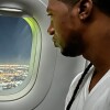 Man looks outside of an airplane window