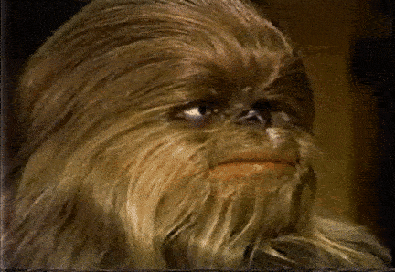 A wookie looks at the camera and cringes