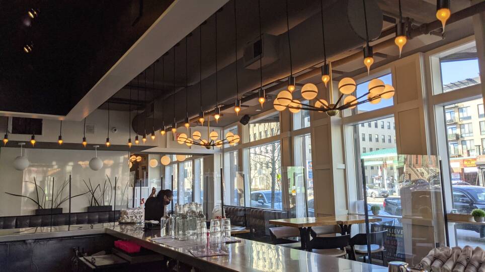A worker cleans the floors of MIDA, an Italian-inspired restaurant in Boston's South End.