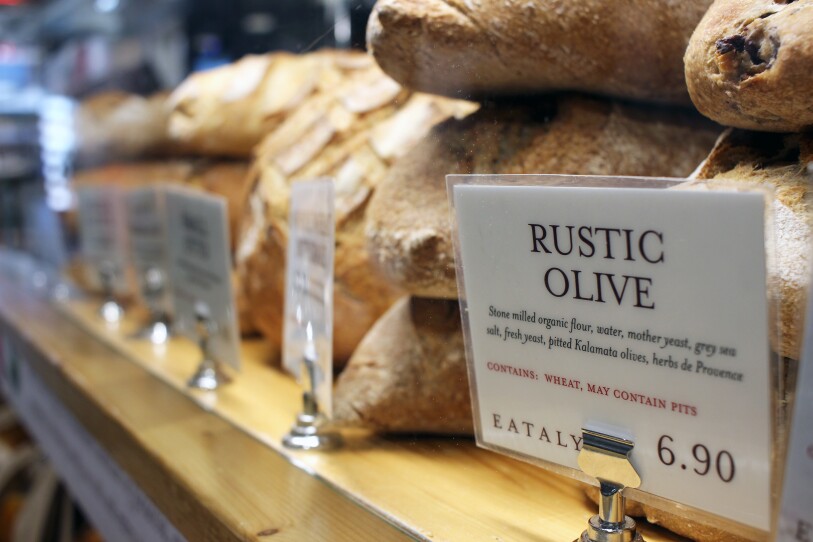 Rows of rustic loaves of bread at La Pannetteria in Eataly Boston