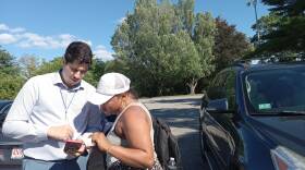 Morad Majjad, left, is a family liaison with the West Springfield Public Schools, seen here outside a hotel that has become an emergency shelter for families without housing. Many families arrived in Massachusetts over the last few months from outside the U.S. They face, among other hurdles, a language barrier. Majjad is multi-lingual and regularly connects with parents and children around school needs.