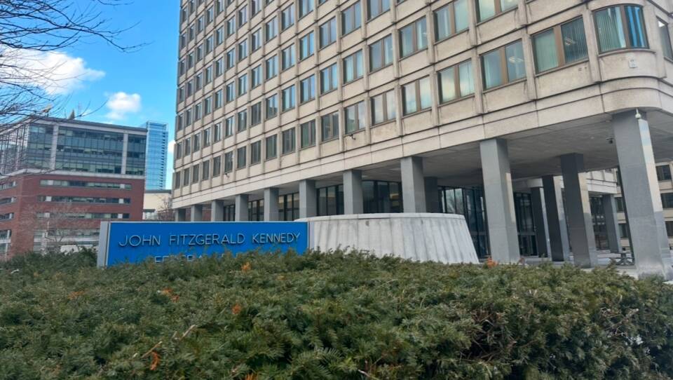 A photo of a blocky government building on a sunny day.