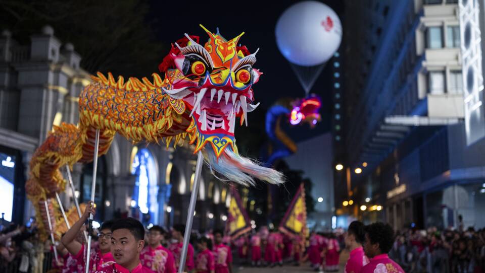A dragon puppet is carried through Hong Kong's streets