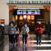 A family wearing face masks walks through Union Station in Los Angeles, California, January 5, 2022. With the Omicron variant driving a surge of Covid-19 cases, California announced January 5, 2022 that a statewide indoor mask mandate, due to expire on January 15, 2022, will be extended until at least February 15, 2022.