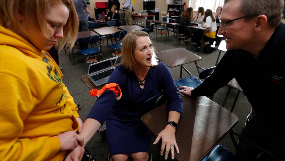 In Parkland, Florida, site of a mass shooting this year, a commission is recommending that so-called 'stop the bleed' kits be put in every classroom.  It comes amid a national push for medical training of educators, like those pictured at Southeast Polk High School in Pleasant Hill, Iowa.